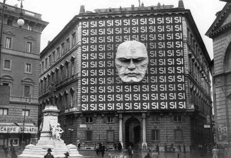 The headquarters of Benito Mussolini and the Italian Fascist party, taken in Rome in 1930. The Engineer head monument is an allusion to worship and power, perhaps even fascistic power.